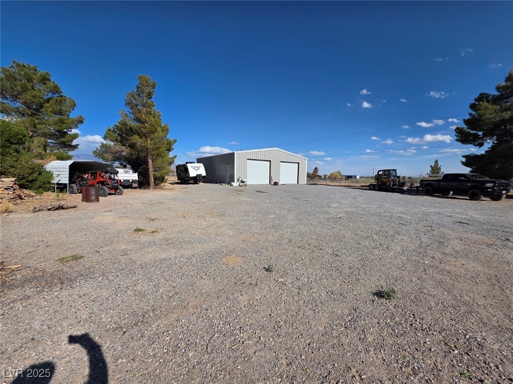 3485 Gally Road Pahrump, NV 89060 - Photo 46 of 90 View of yard featuring a garage and an outbuilding