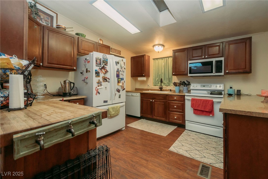3485 Gally Road Pahrump, NV 89060 - Photo 55 of 90 Kitchen with white appliances, light countertops, dark wood-style flooring, and lofted ceiling