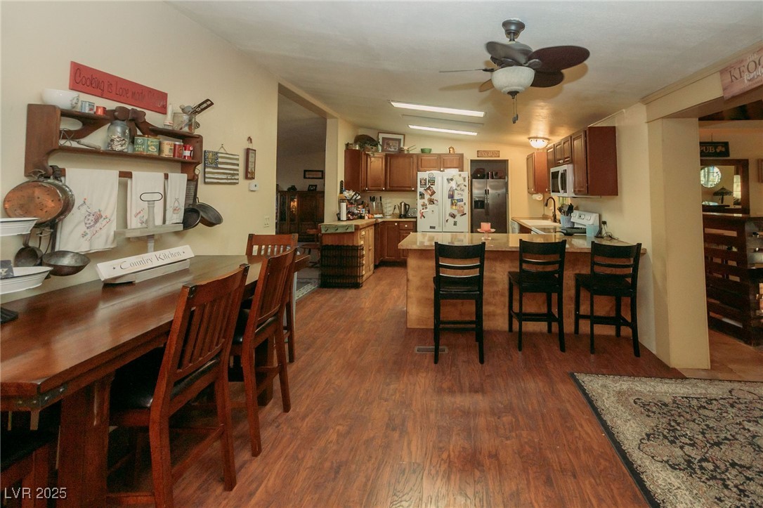 3485 Gally Road Pahrump, NV 89060 - Photo 56 of 90 Dining room featuring a ceiling fan and dark wood-style flooring