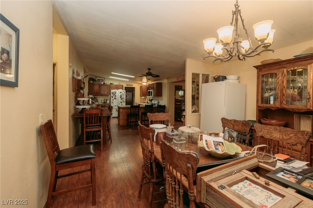 3485 Gally Road Pahrump, NV 89060 - Photo 57 of 90 Dining area featuring a chandelier, dark wood-style flooring, and ceiling fan