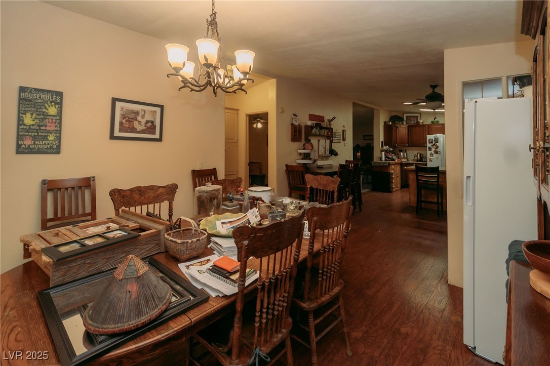 3485 Gally Road Pahrump, NV 89060 - Photo 58 of 90 Dining space with a chandelier, dark wood-style floors, and a ceiling fan