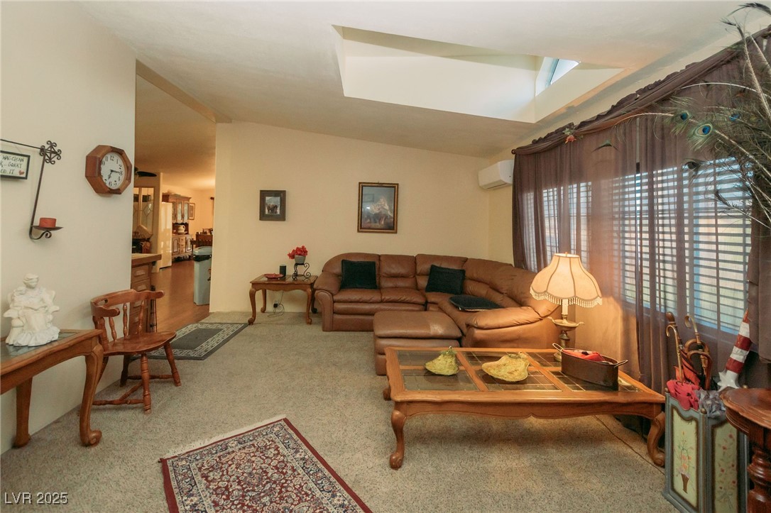 3485 Gally Road Pahrump, NV 89060 - Photo 63 of 90 Living area with vaulted ceiling, carpet floors, and a wall unit AC