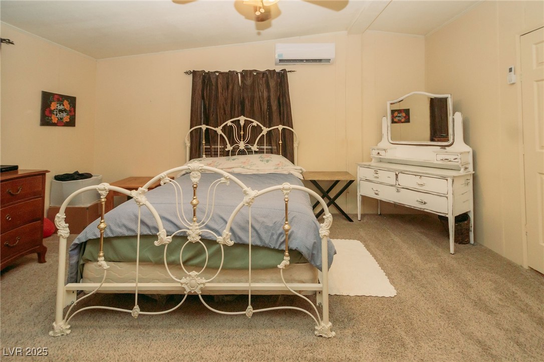 3485 Gally Road Pahrump, NV 89060 - Photo 64 of 90 Bedroom with carpet floors, a ceiling fan, and a wall mounted air conditioner