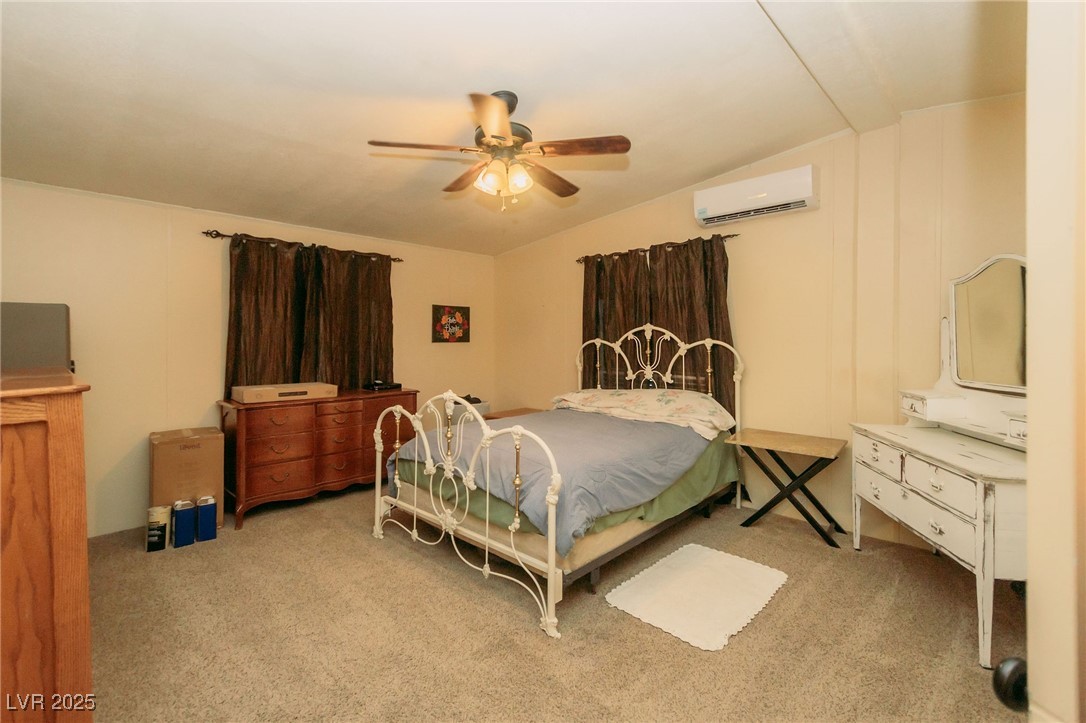 3485 Gally Road Pahrump, NV 89060 - Photo 65 of 90 Bedroom featuring lofted ceiling, carpet floors, ceiling fan, and a wall unit AC