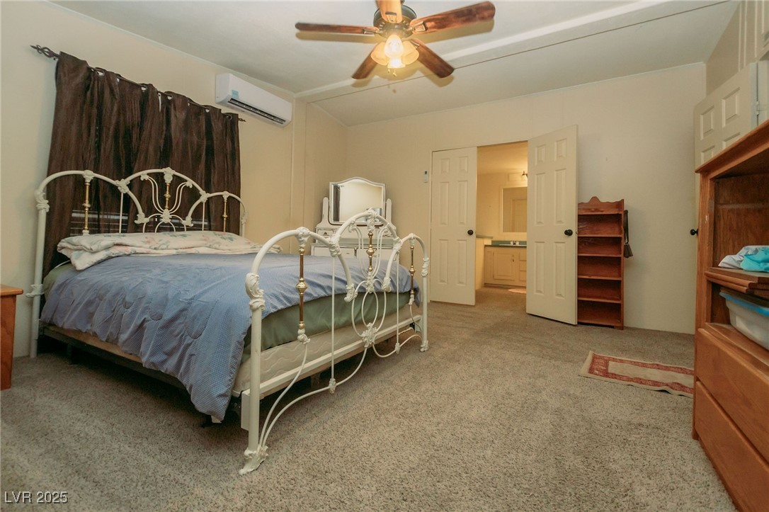3485 Gally Road Pahrump, NV 89060 - Photo 66 of 90 Carpeted bedroom with a wall mounted AC and ceiling fan
