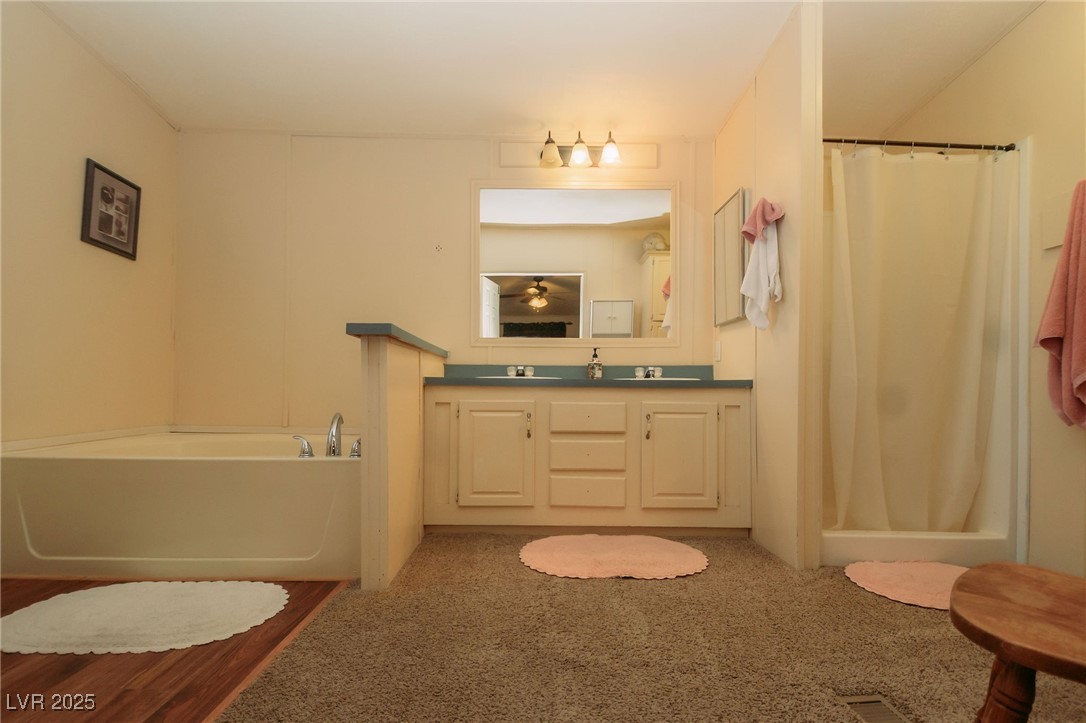 3485 Gally Road Pahrump, NV 89060 - Photo 69 of 90 Bathroom with curtained shower, double vanity, carpet flooring, and a bath