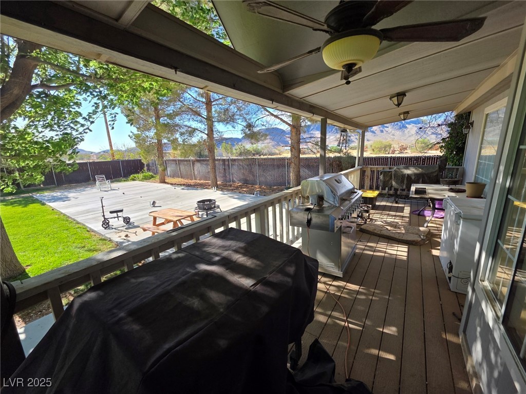 3485 Gally Road Pahrump, NV 89060 - Photo 79 of 90 Wooden terrace featuring a fenced backyard, ceiling fan, and area for grilling