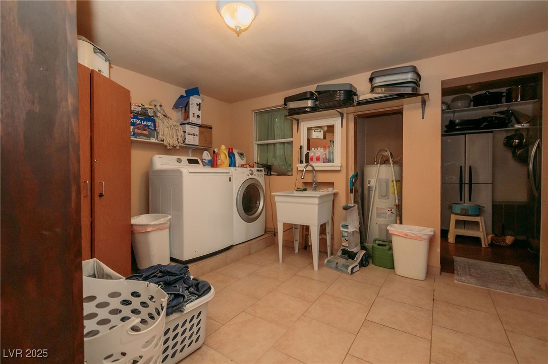 3485 Gally Road Pahrump, NV 89060 - Photo 10 of 90 Laundry area featuring washer and dryer, electric water heater, and tile patterned floors
