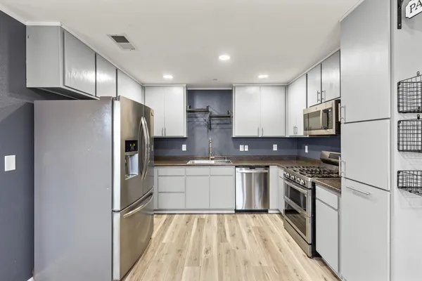 a view of a room with wooden floor and windows