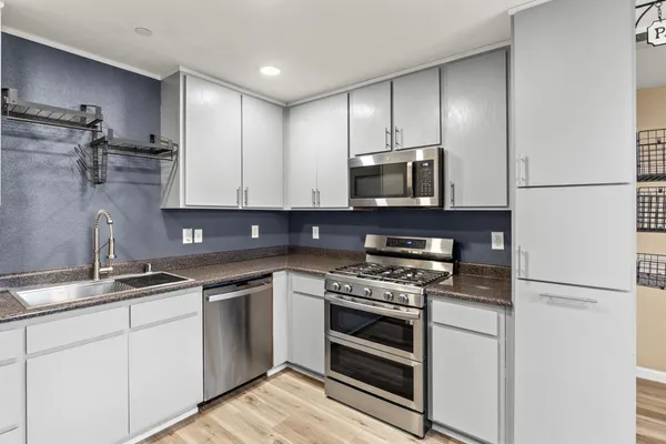 a work room with furniture wooden floor and windows