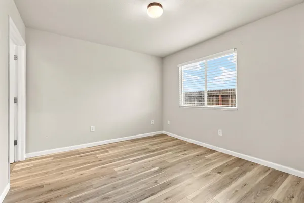 a view of a room with wooden floor and windows