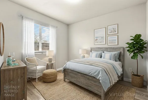 an aerial view of a city with lots of residential buildings ocean and mountain view in back