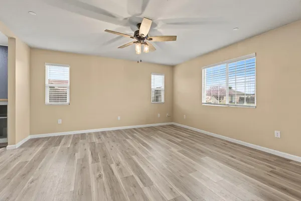 a living room with furniture a chandelier and a wooden floor