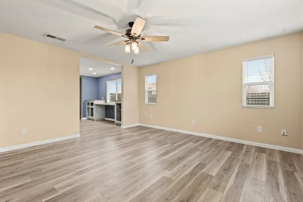 a living room with furniture a flat screen tv and a window