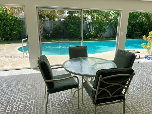 a view of a yard with a table and chairs