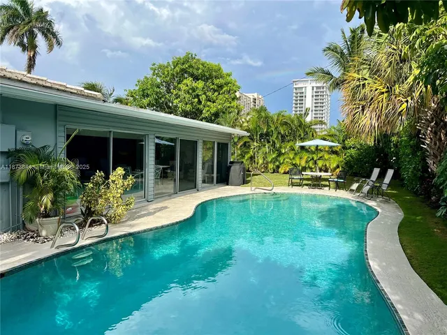 a view of house with swimming pool and porch with furniture