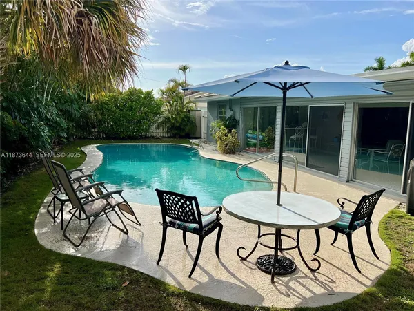 a patio with a yard table and chairs