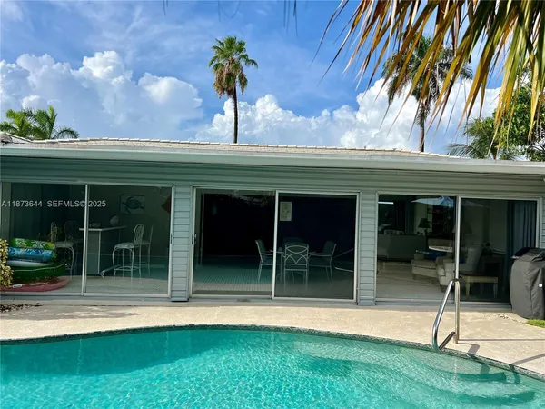 a backyard of a house with table and chairs