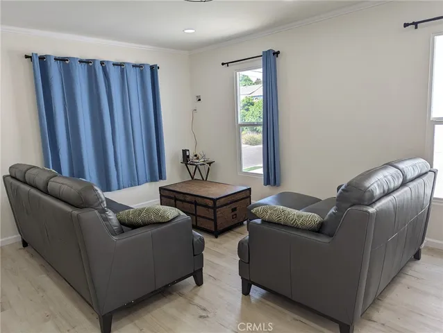 a view of a workspace room with furniture and wooden floor
