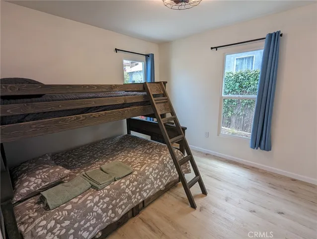 a bed sitting in a bedroom next to a window