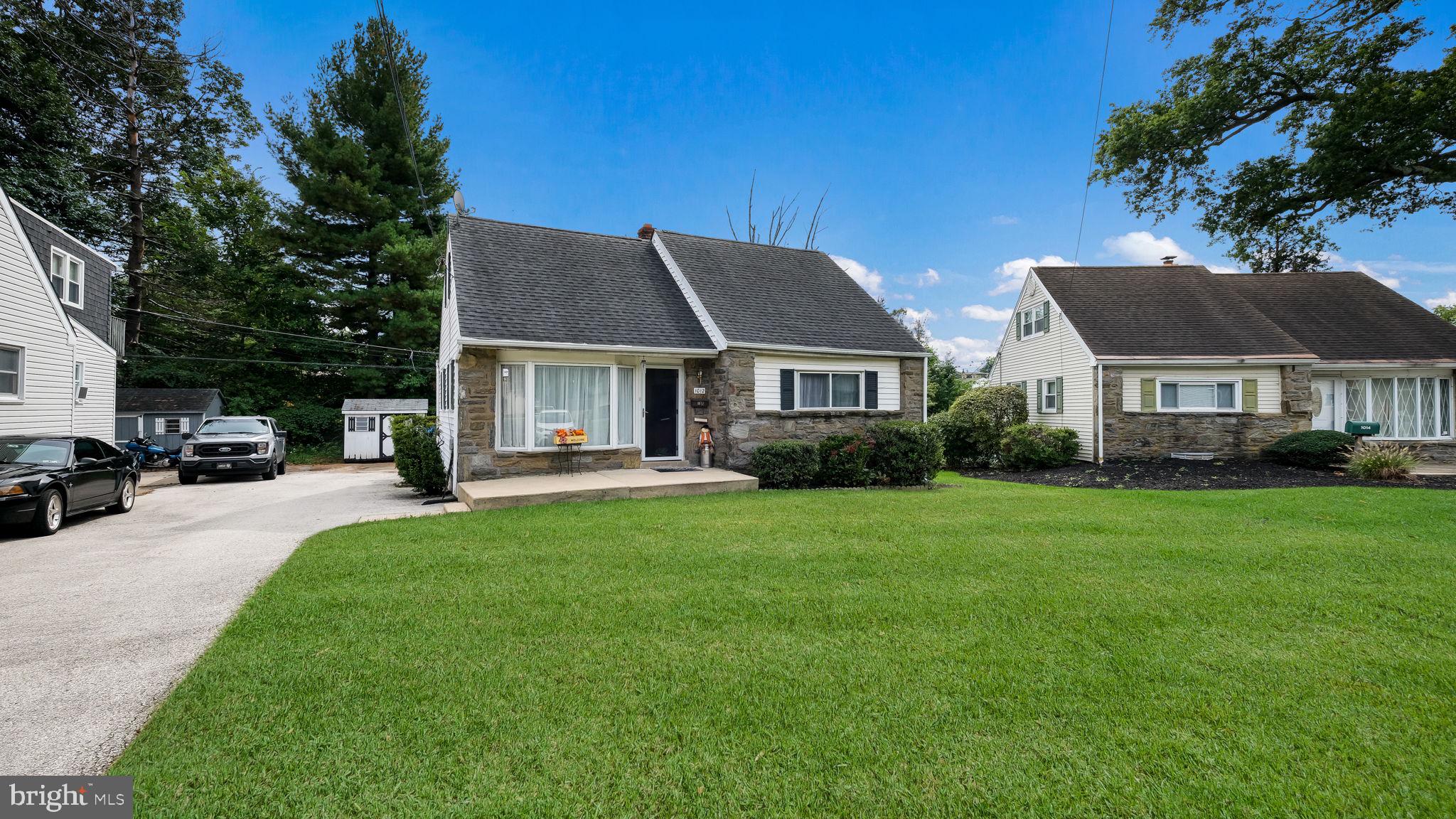1012 Brook Avenue Secane, PA 19018 - Photo 2 of 28 a front view of a house with a yard and trees
