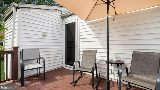 a view of a patio with table and chairs and iron fence