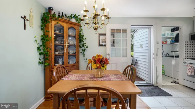 a view of a dining room with furniture and chandelier