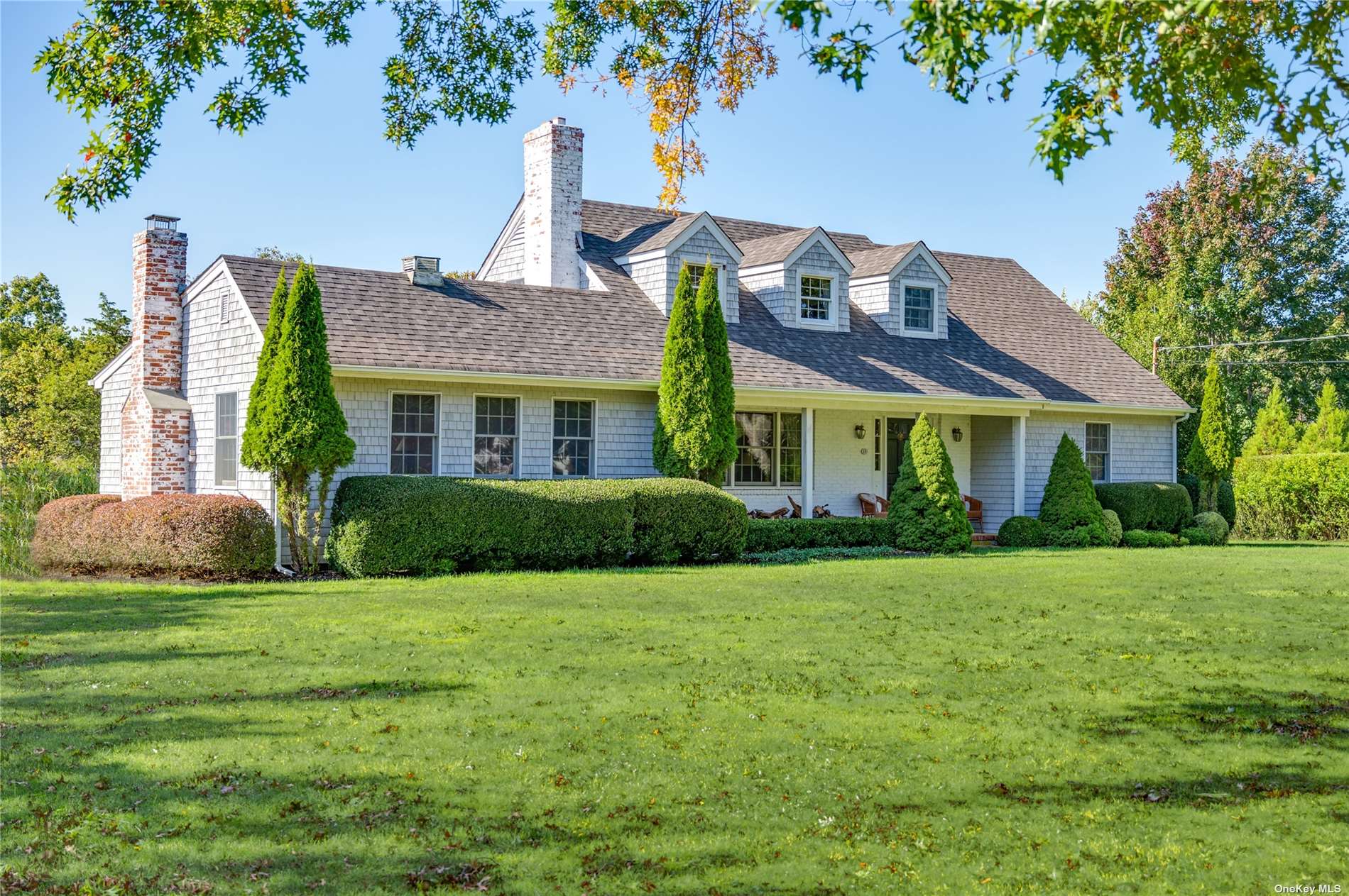 13 Rogers Lane Remsenburg, NY 11960 - Photo 1 of 1 a front view of a house with a garden