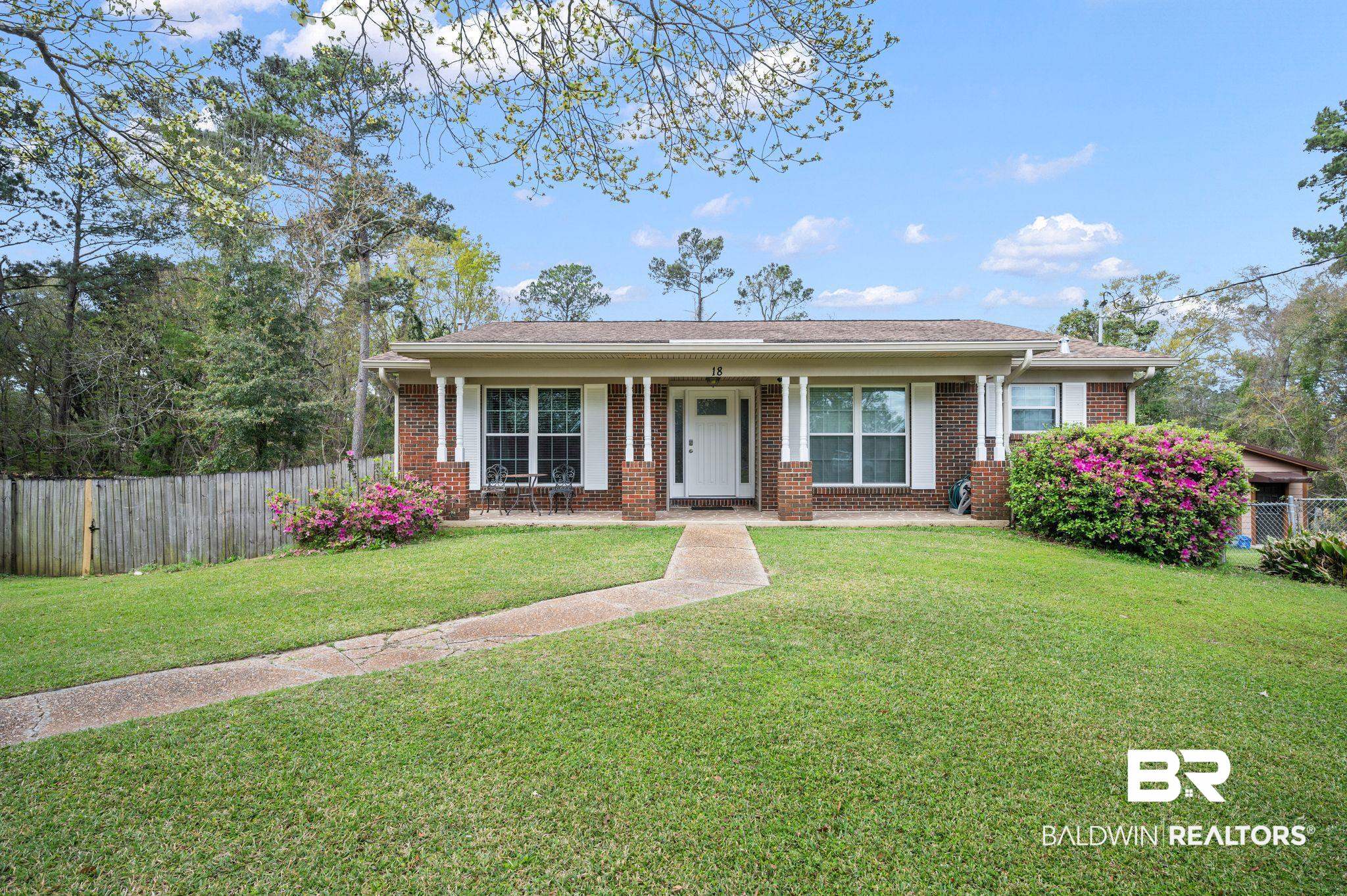 18 Lee Circle Spanish Fort, AL 36527 - Photo 2 of 50 View of front facade brick home, a front yard, and fenced back yard.