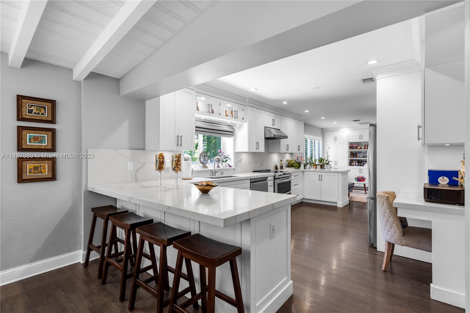 2400 Trapp Avenue Miami, FL 33133 - Photo 13 of 47 a large kitchen with a table and chairs