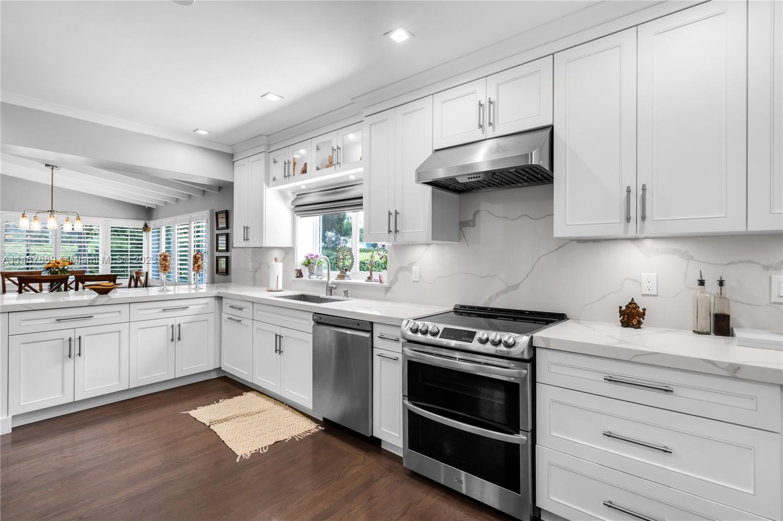 2400 Trapp Avenue Miami, FL 33133 - Photo 15 of 47 a kitchen with stainless steel appliances granite countertop a stove and a sink