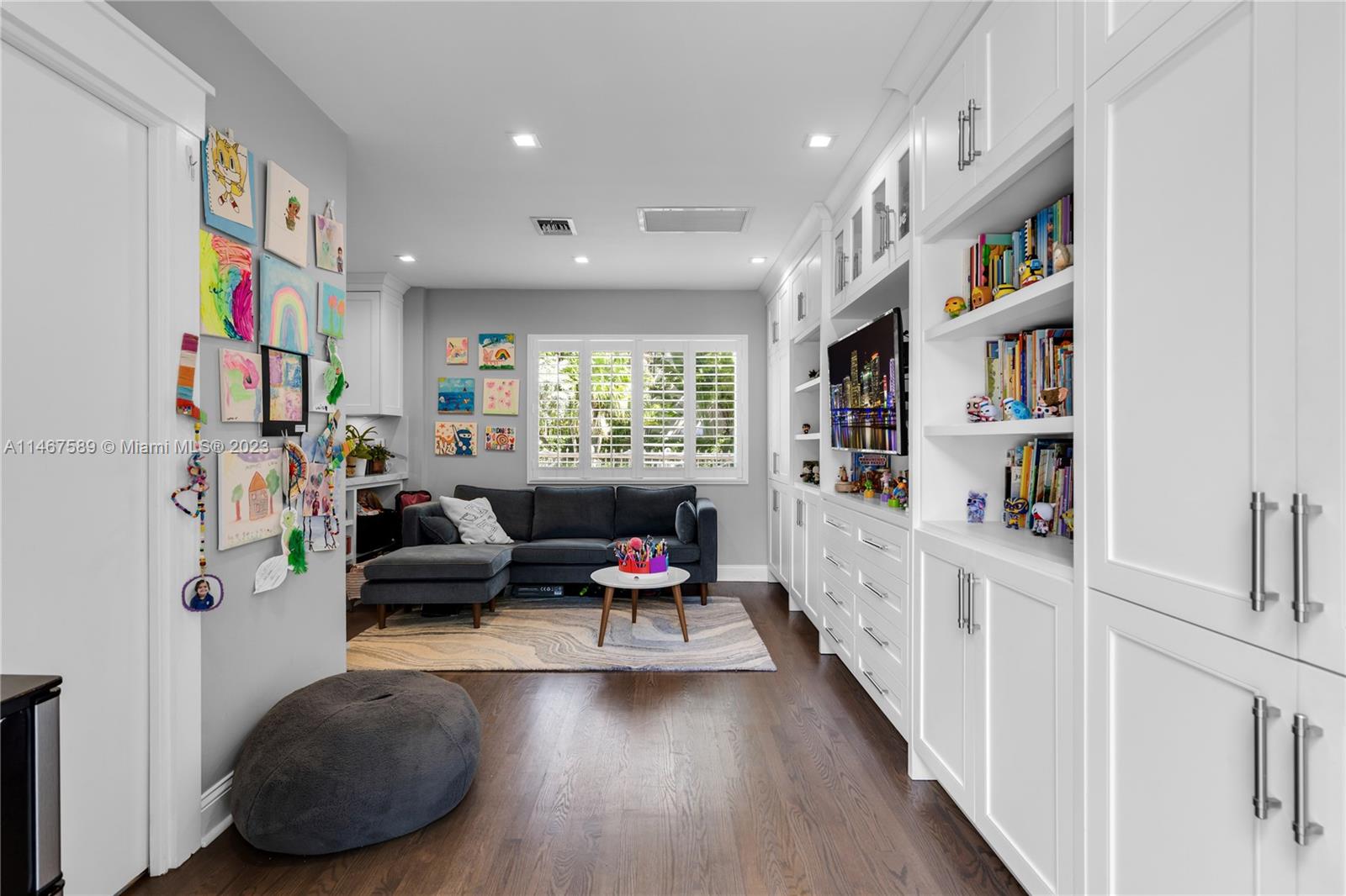 2400 Trapp Avenue Miami, FL 33133 - Photo 16 of 47 a living room with furniture and a book shelf