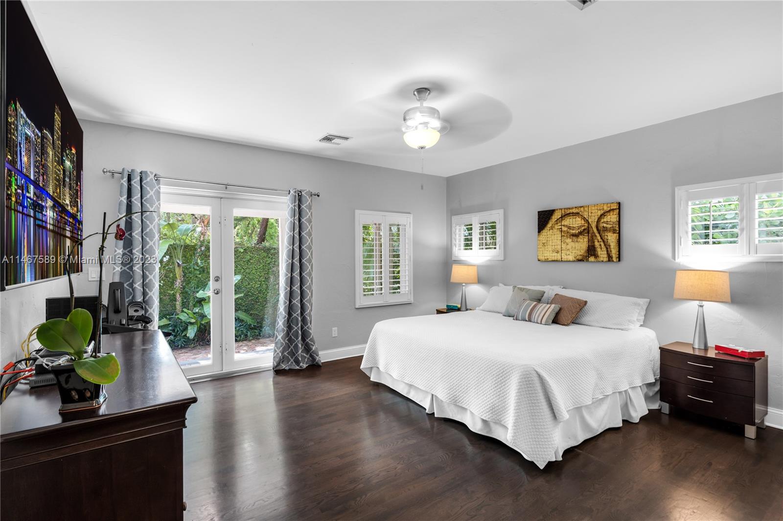 2400 Trapp Avenue Miami, FL 33133 - Photo 22 of 47 a bedroom with a large bed and a potted plant