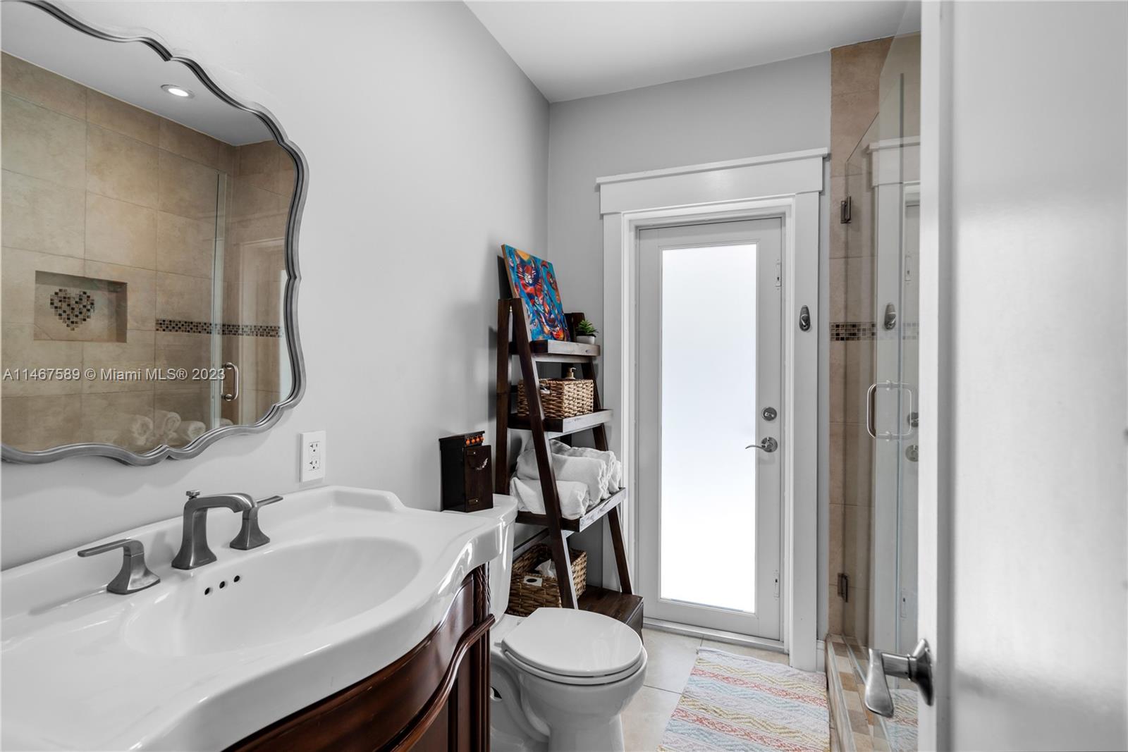 2400 Trapp Avenue Miami, FL 33133 - Photo 29 of 47 a bathroom with a sink a toilet and a mirror