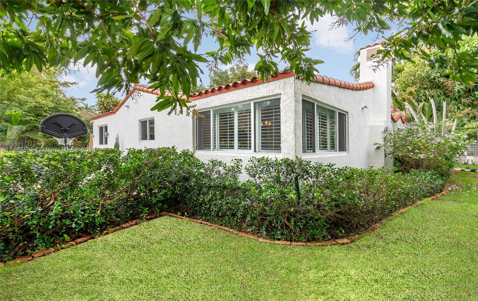 2400 Trapp Avenue Miami, FL 33133 - Photo 38 of 47 a view of a house with a yard and potted plants