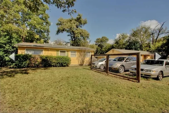 an outdoor view of a house with garden