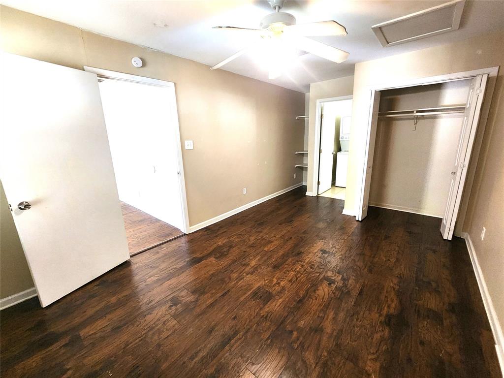 610 Genard Street, Unit A Austin, TX 78751 - Photo 13 of 15 Unfurnished bedroom with attic access, a closet, dark wood-style floors, and ceiling fan