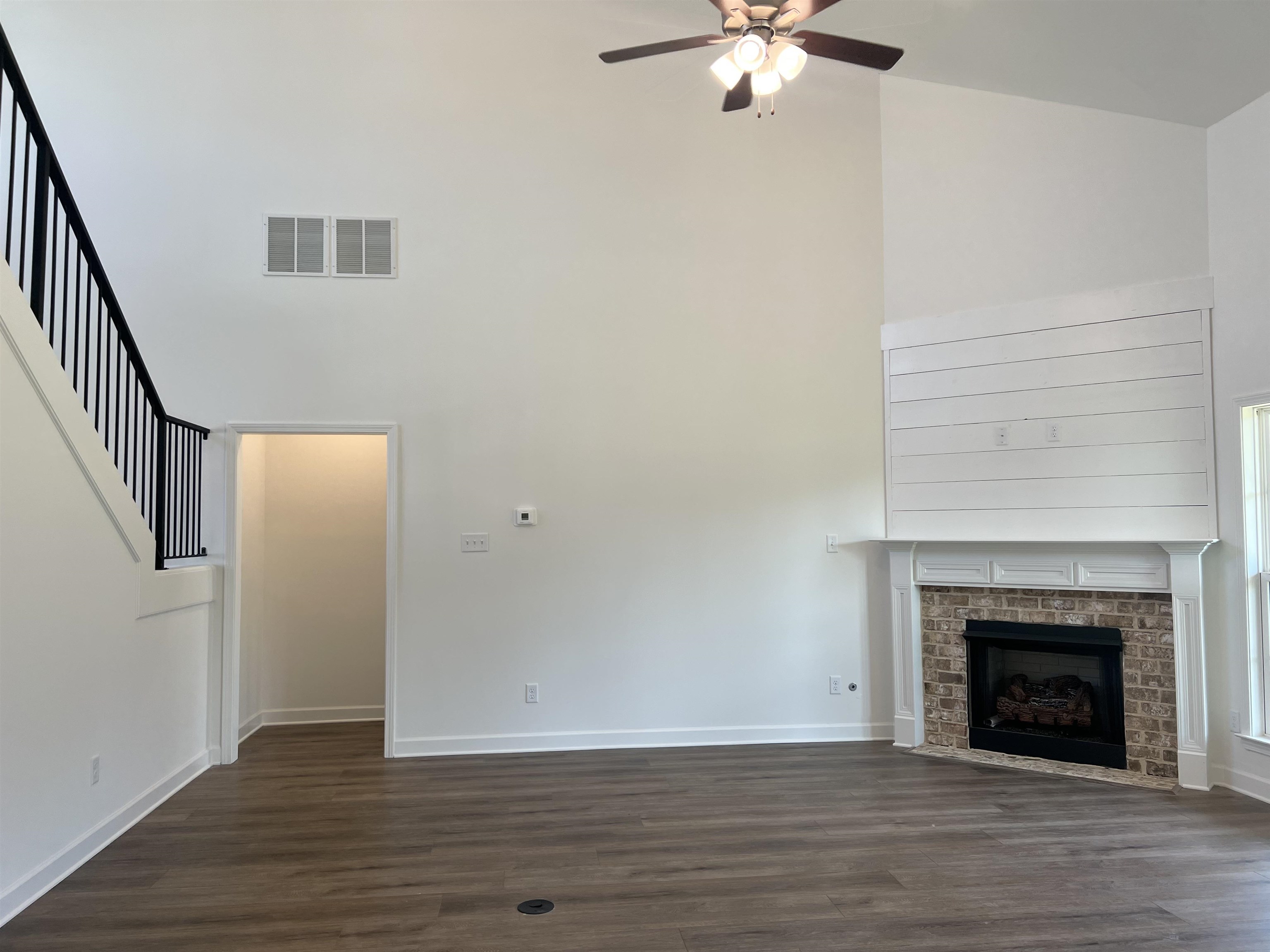 45 Rolling Hill Drive Collierville, TN 38017 - Photo 10 of 24 a view of an empty room with wooden floor and a fireplace