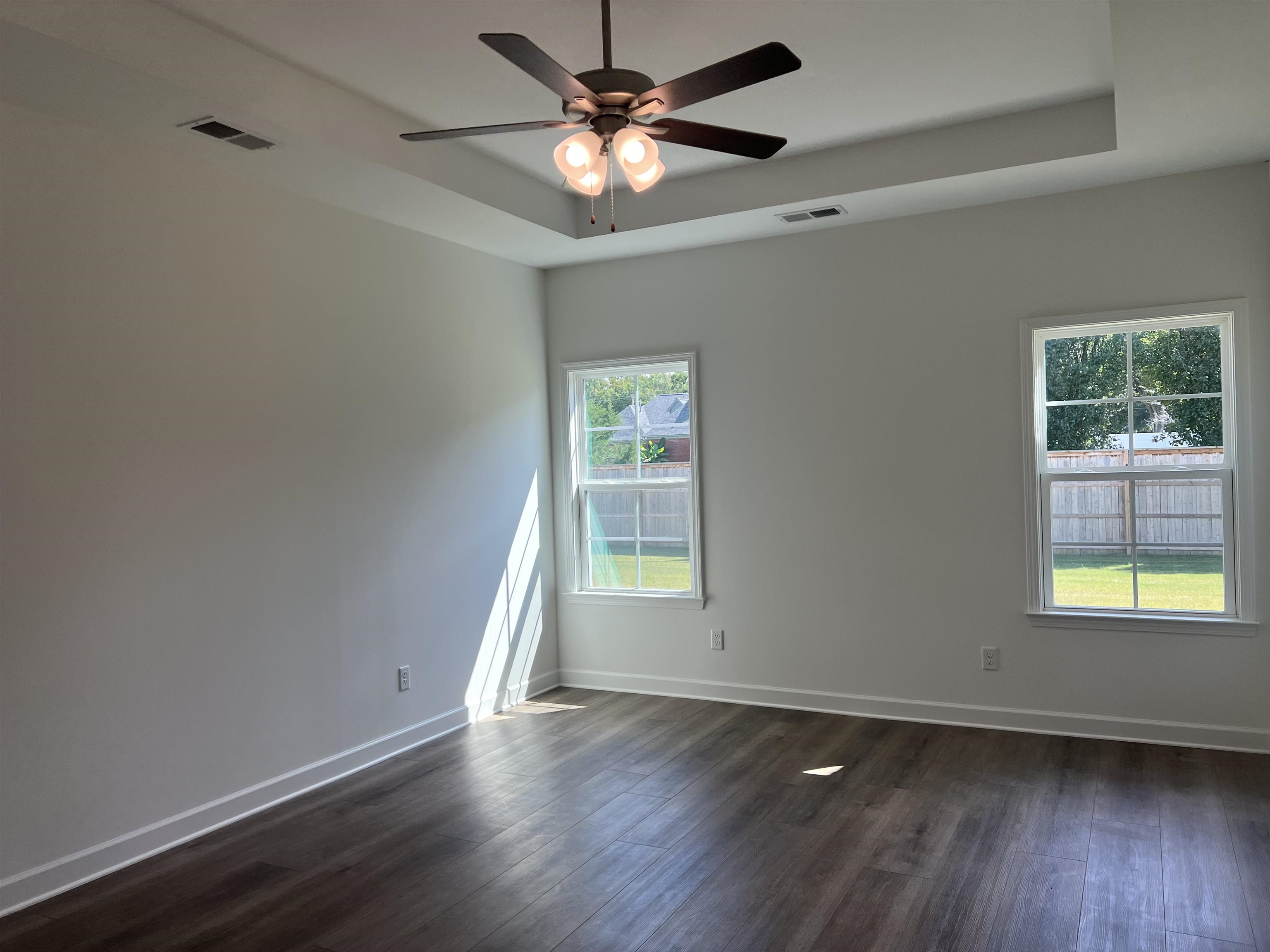 45 Rolling Hill Drive Collierville, TN 38017 - Photo 11 of 24 an empty room with wooden floor chandelier fan and windows