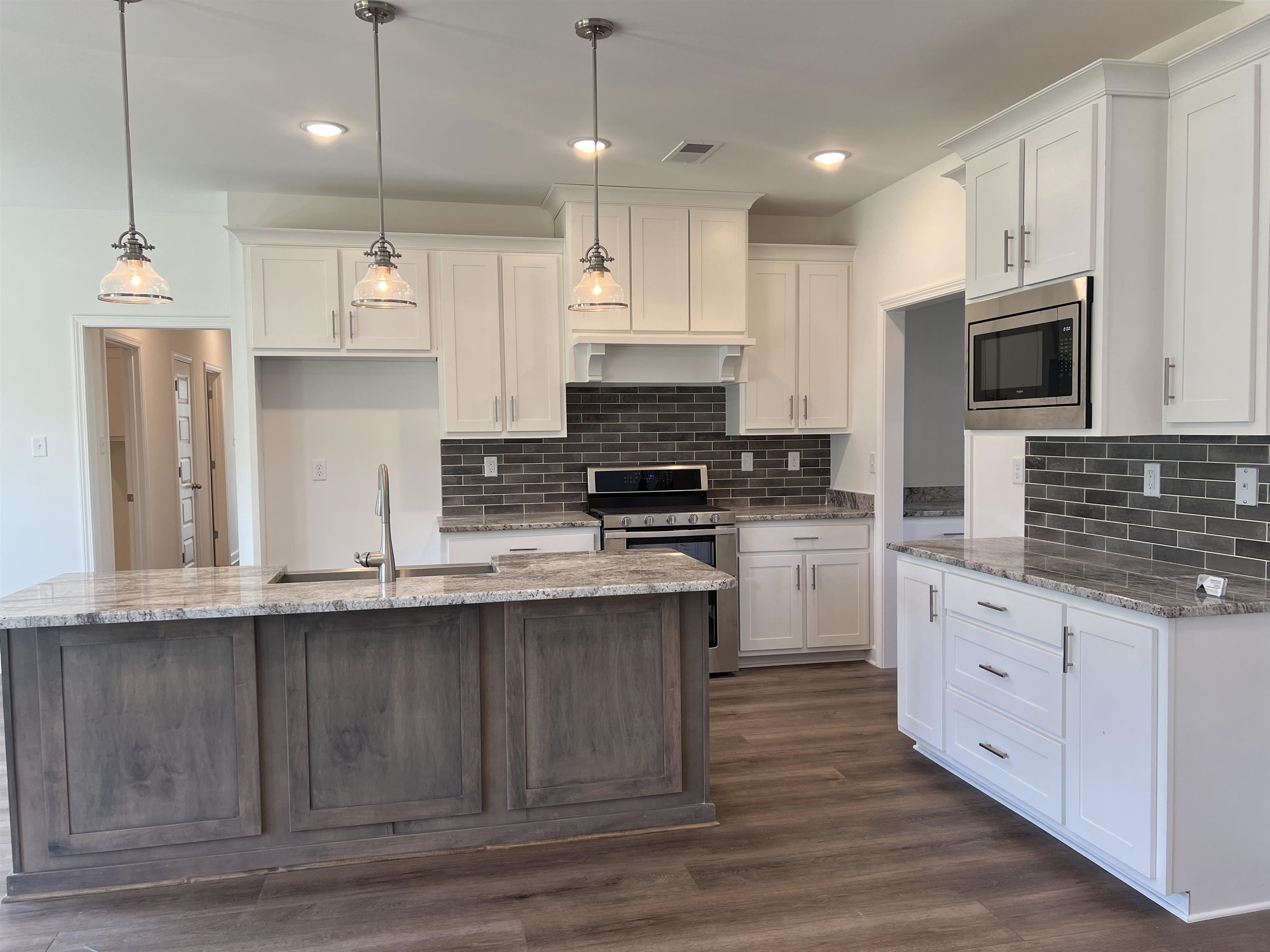 45 Rolling Hill Drive Collierville, TN 38017 - Photo 5 of 24 a kitchen with granite countertop a stove a sink a refrigerator and a microwave