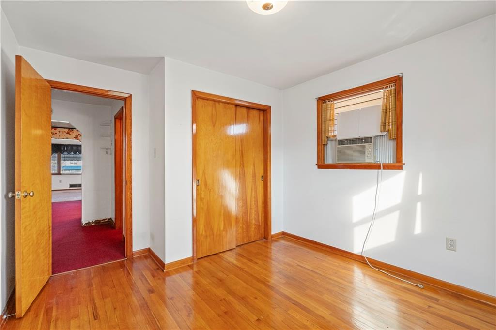 306 Allegheny Street Tarentum, PA 15084 - Photo 6 of 10 a view of an empty room with wooden floor and a bathroom