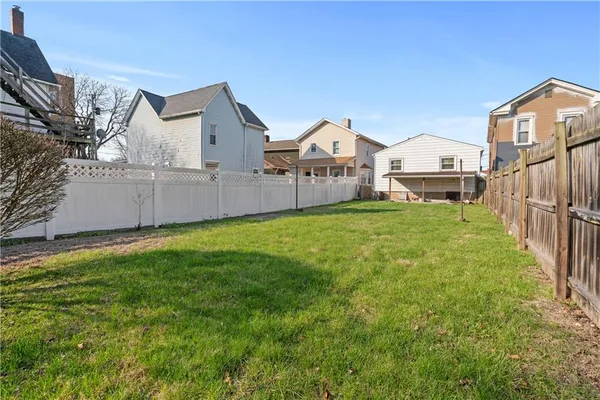 a view of a house with a yard and garage