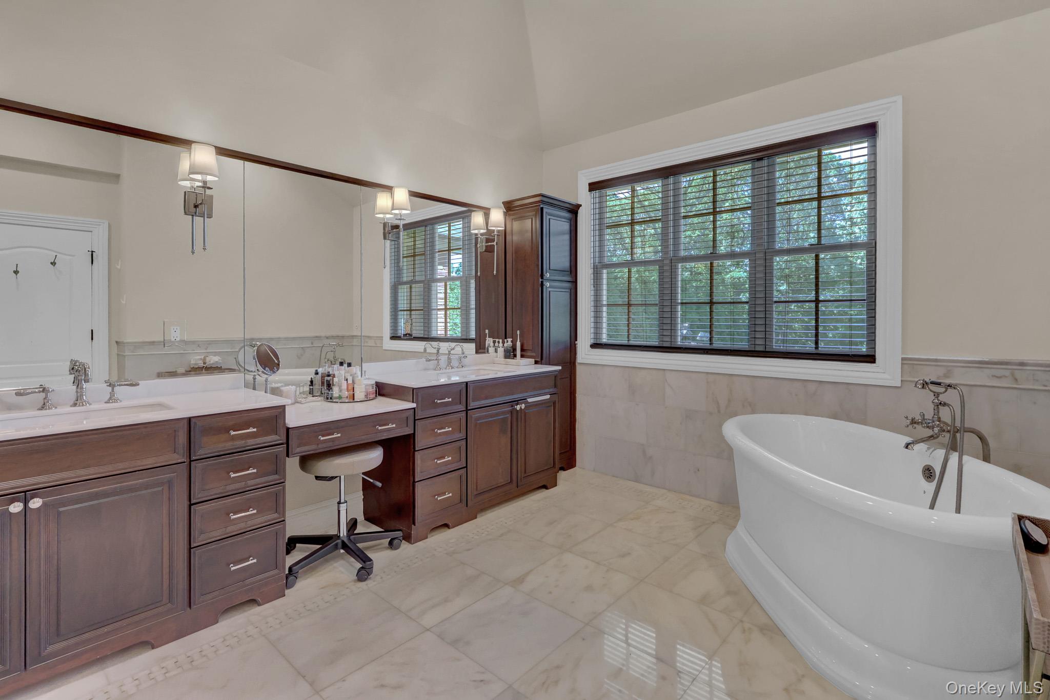 36 Old Field Road Setauket, NY 11733 - Photo 32 of 42 a bathroom with a tub sink double vanity and mirror