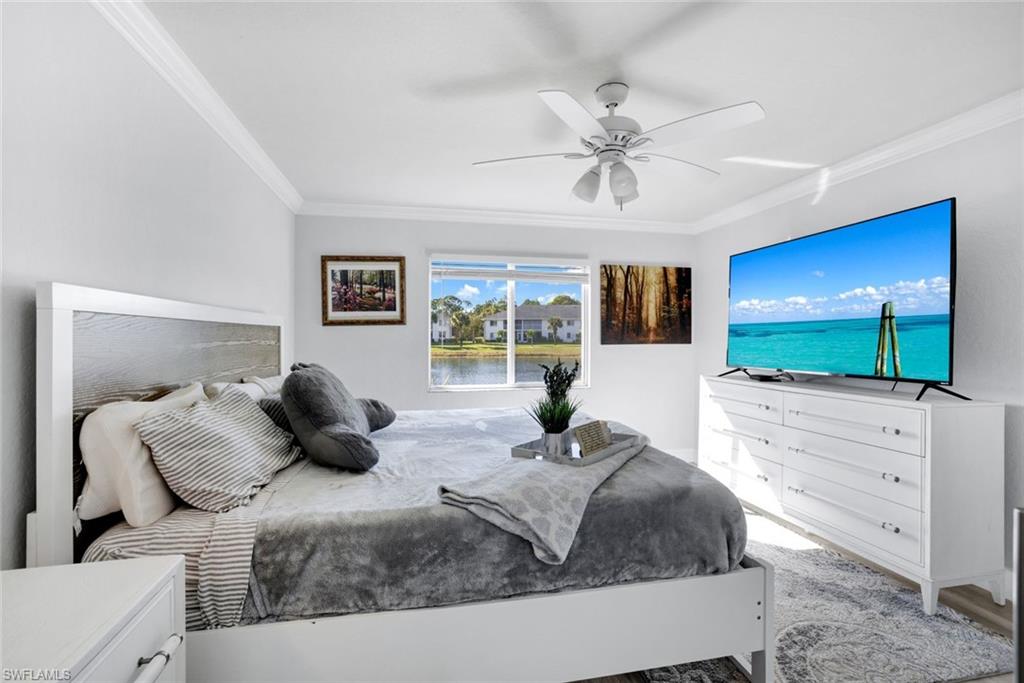 409 Gabriel Circle, Unit 2203 Naples, FL 34104 - Photo 15 of 24 Bedroom featuring ceiling fan, light hardwood / wood-style floors, and ornamental molding