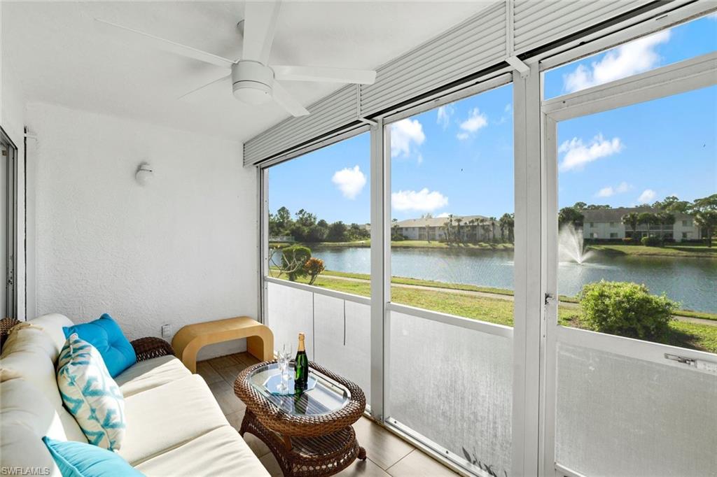 409 Gabriel Circle, Unit 2203 Naples, FL 34104 - Photo 18 of 24 Sunroom featuring ceiling fan and a water view