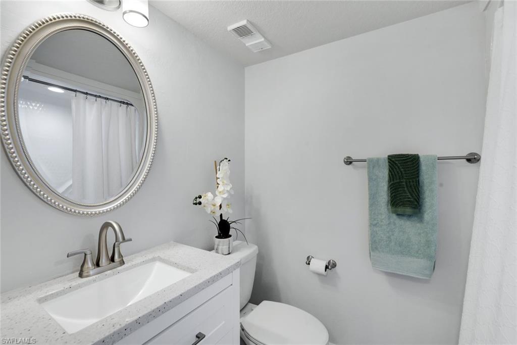 409 Gabriel Circle, Unit 2203 Naples, FL 34104 - Photo 6 of 24 Bathroom #2 featuring vanity, toilet and tub/shower