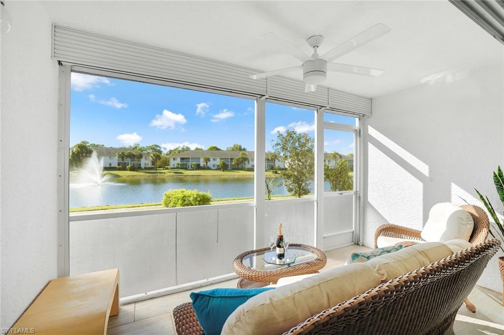 409 Gabriel Circle, Unit 2203 Naples, FL 34104 - Photo 7 of 24 Sunroom / solarium featuring ceiling fan and a water view