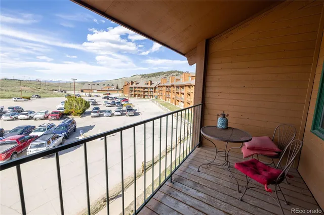 a view of a balcony with chair and wooden floor