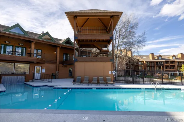 a front view of a house with swimming pool and sitting area