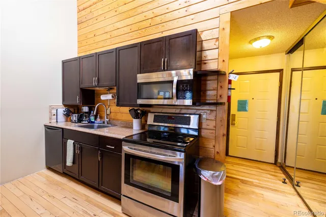 a kitchen with a sink cabinets and appliances